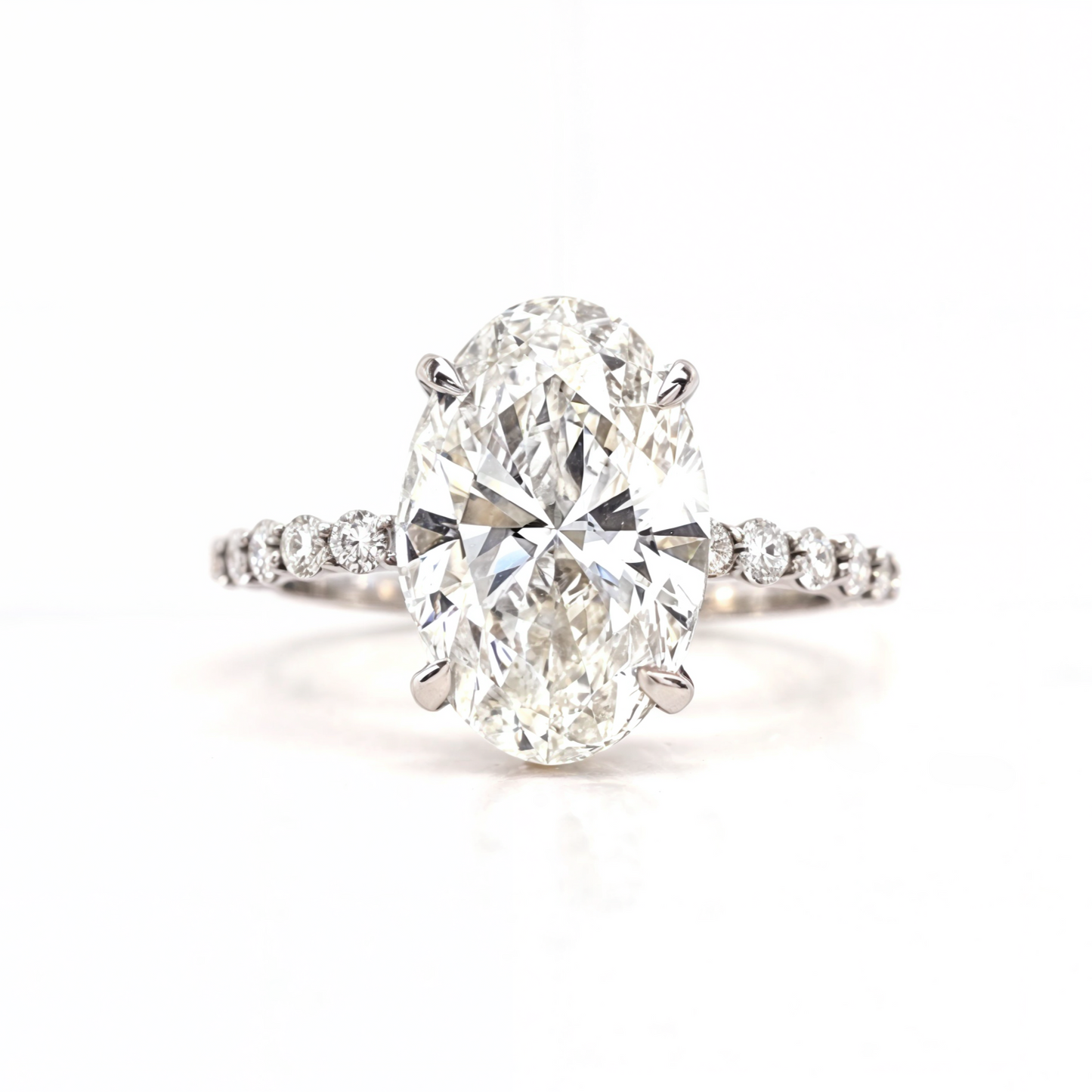 Merry – " 4ct " Oval Solitaire in 18K with round Side Stones and hidden halo (Ready) - Prime & Pure