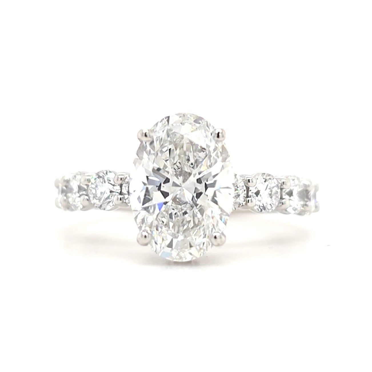 Maggie – Oval Solitaire with Hidden Halo and Round Accents band