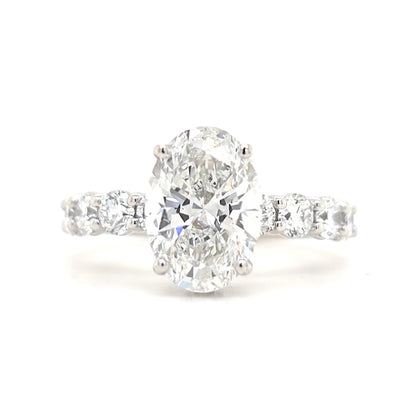 Maggie – Oval Solitaire with Hidden Halo and Round Accents band